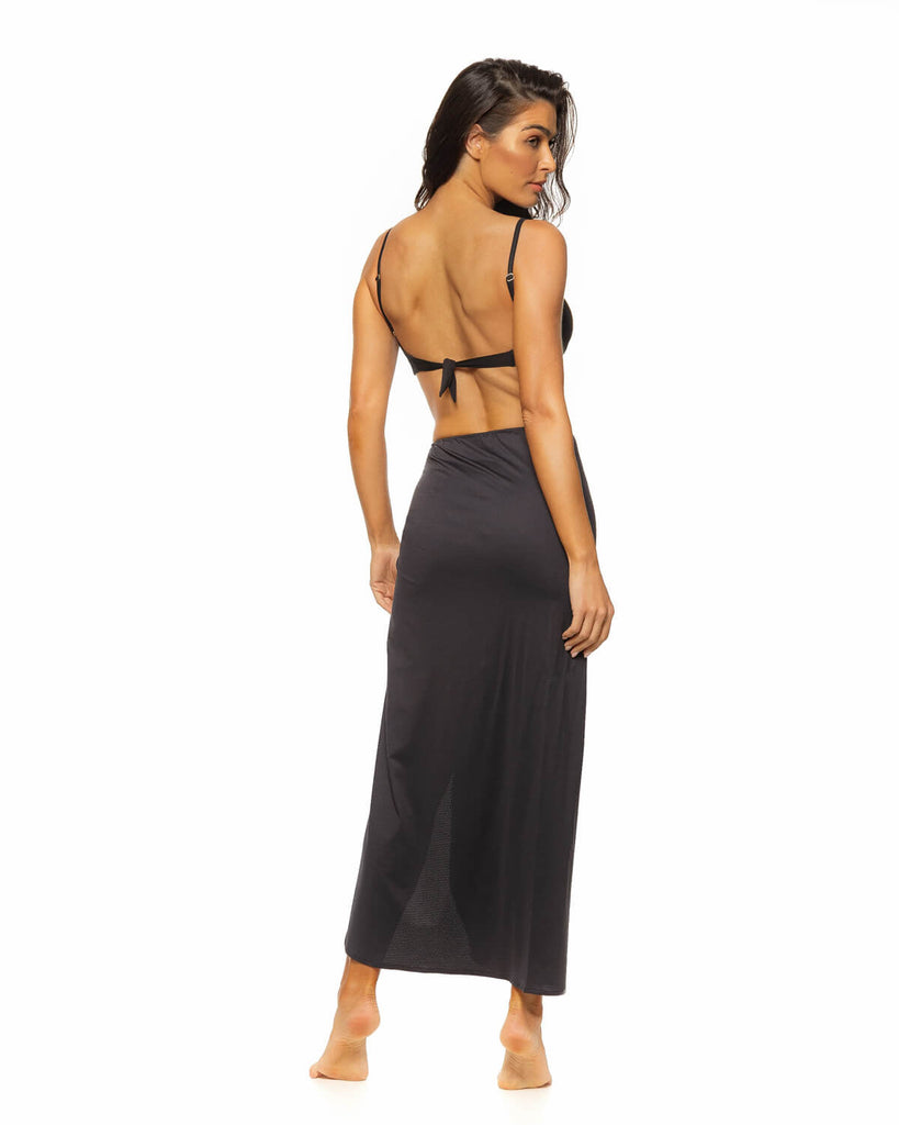 Long skirt in a super soft lycra textured fabric features a high front slit and ruching with bottom details on the side